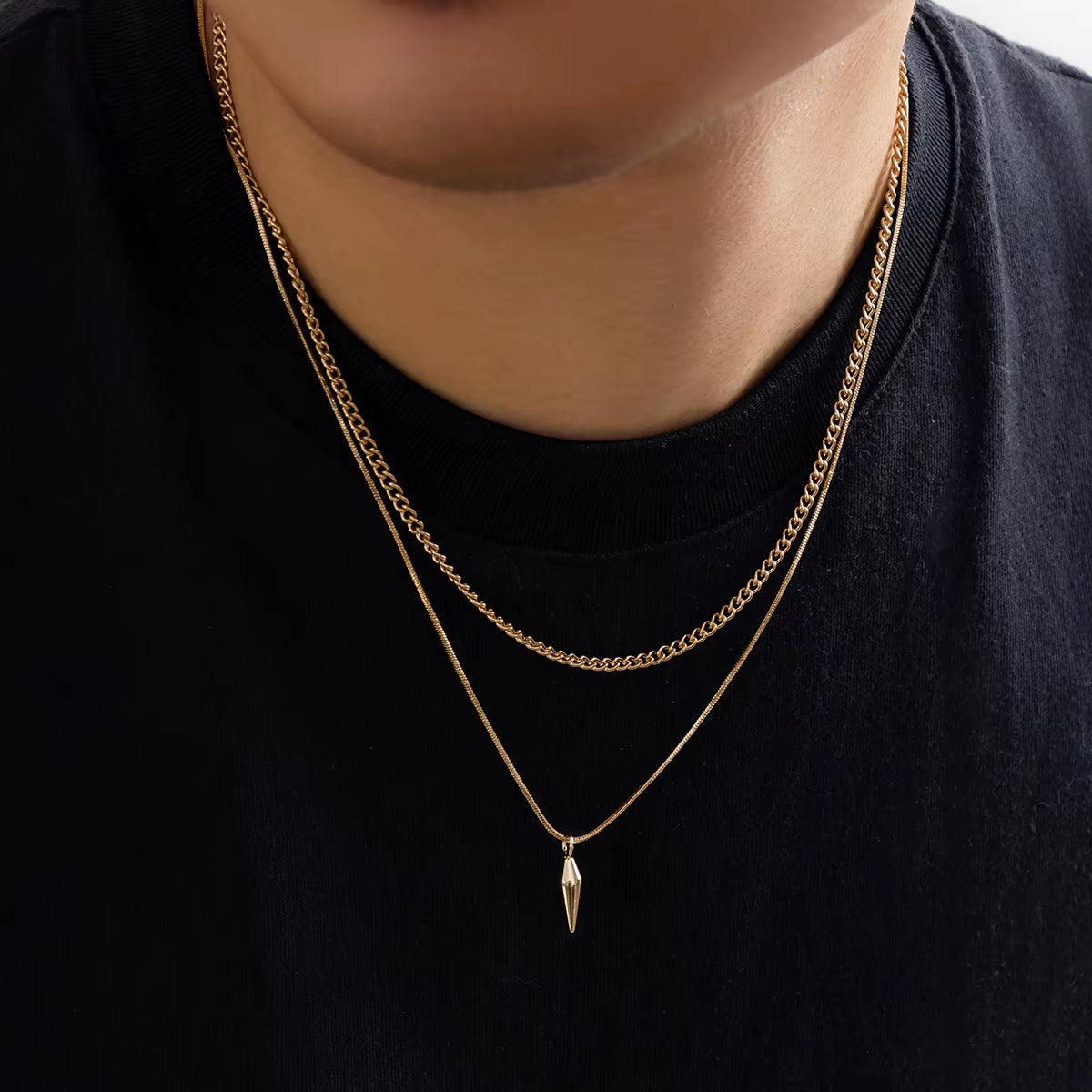 2Pcs Stainless Steel Rivet Pendant Snake Chain Necklace worn by a person, featuring layered gold chains and a pendant.2Pcs Stainless Steel Rivet Pendant Snake Chain Necklace 
